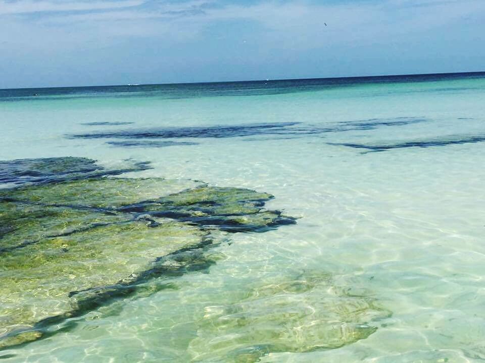 water, sea, tranquil scene, tranquility, scenics, beauty in nature, sky, horizon over water, nature, idyllic, rock - object, day, rippled, beach, outdoors, no people, blue, waterfront, cloud - sky, remote