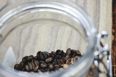 High angle view of roasted coffee bean in glass jar on table