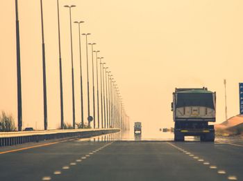 Road against clear sky in city