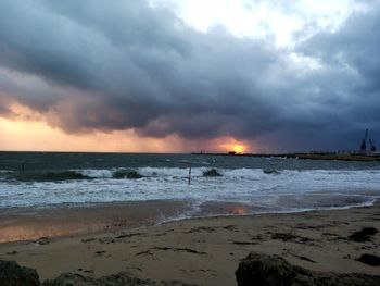 Scenic view of beach against sky during sunset