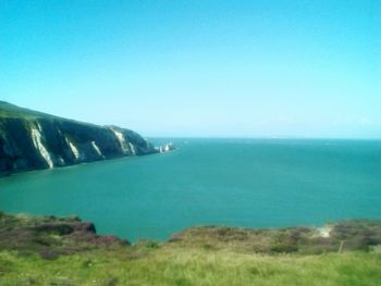 Scenic view of sea against clear blue sky