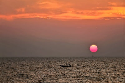 Scenic view of sea against orange sky