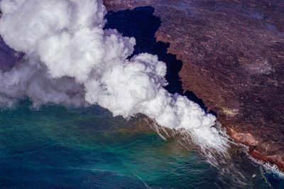 High angle view of smoke emitting from rock