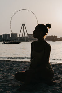 Smiling woman sitting on beach