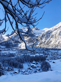 Scenic view of snow covered mountains against sky