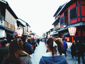 People on street in city against clear sky