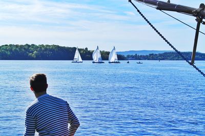 Rear view of man on boat sailing in sea