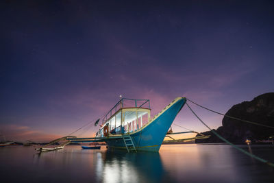 Sailboat on sea against sky at night