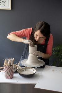 Woman holding coffee cup on table