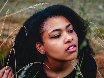 Close-up portrait of young woman looking away