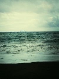 Scenic view of sea against cloudy sky