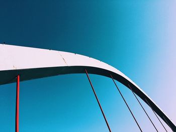 Low angle view of bridge against clear blue sky