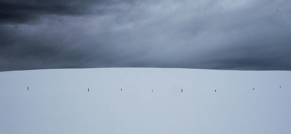 Snow covered landscape against sky