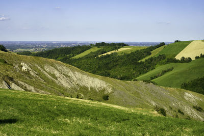 Scenic view of landscape and sea against sky