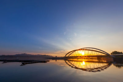Reflection of bridge against sky during sunset