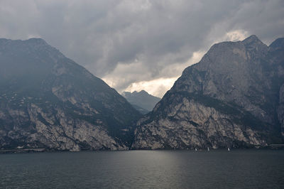 Scenic view of sea and mountains against sky