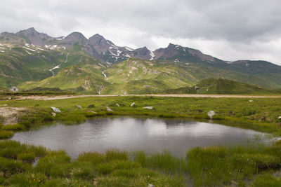 Scenic view of lake and mountains against sky