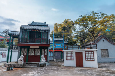 Exterior of building by trees against sky