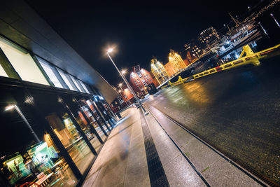 Illuminated city street and buildings at night