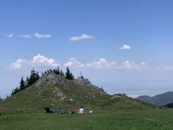 People on landscape against sky