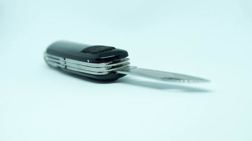 High angle view of telephone on table against white background