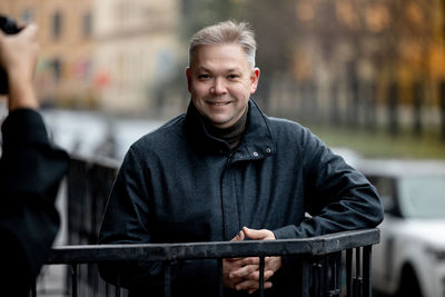 Portrait of smiling man in balcony outdoors