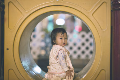 Close-up of girl sitting at playground