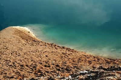 Scenic view of rocky mountain by sea