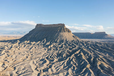 Dramatic aerial view of a sandstone mountain called factory butte rock