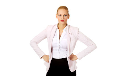 Portrait of young woman standing against white background