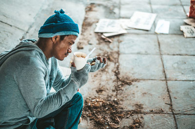 Side view of man holding ice cream