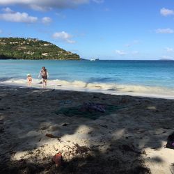 People at beach against sky