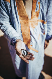 Close-up of senior man holding compass in smara refugee camp, tindouf, algeria