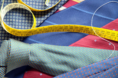 Close-up of colorful neckties with tape measure