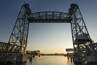 Low angle view of bridge against sky during sunset