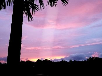 Low angle view of silhouette trees against romantic sky