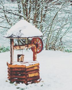 Snow covered metal structure on field during winter