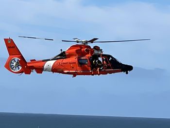 Low angle view of airplane flying against sky