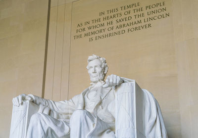 Low angle view of statue against wall