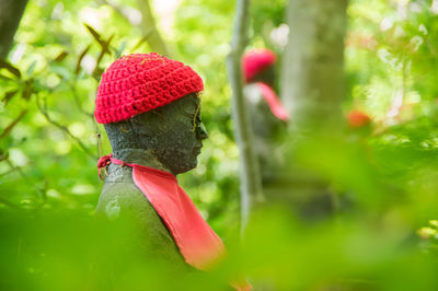 Side view of statue against trees