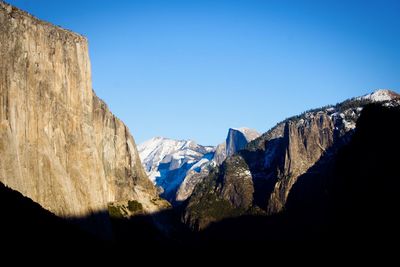 Panoramic view of mountains against clear blue sky