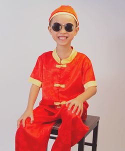 Portrait of smiling boy against gray background