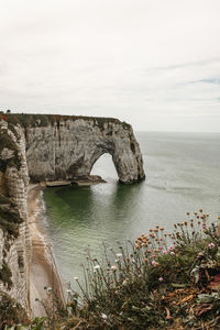 Rock formations by sea against sky