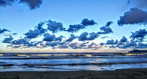 Scenic view of beach against blue sky