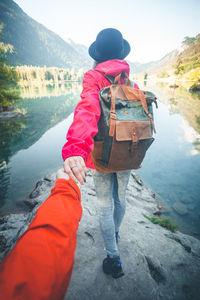 Rear view of man on lake against mountain