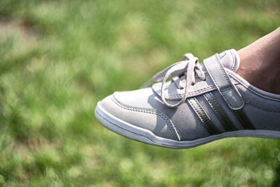 Low section of person wearing canvas shoes