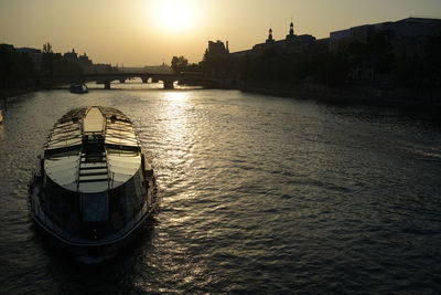 View of boats in river at sunset