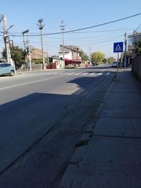 Cars on road against sky in city