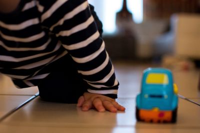 Low section of boy wearing hat at home