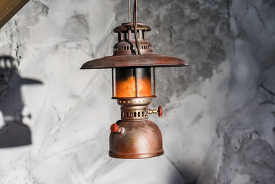 Close-up of lantern hanging in snow
